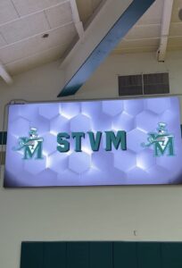 image shows a video board in the gym at st. vincent-st. mary high school in akron, ohio
