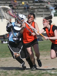 image shows a girls lacrosse game