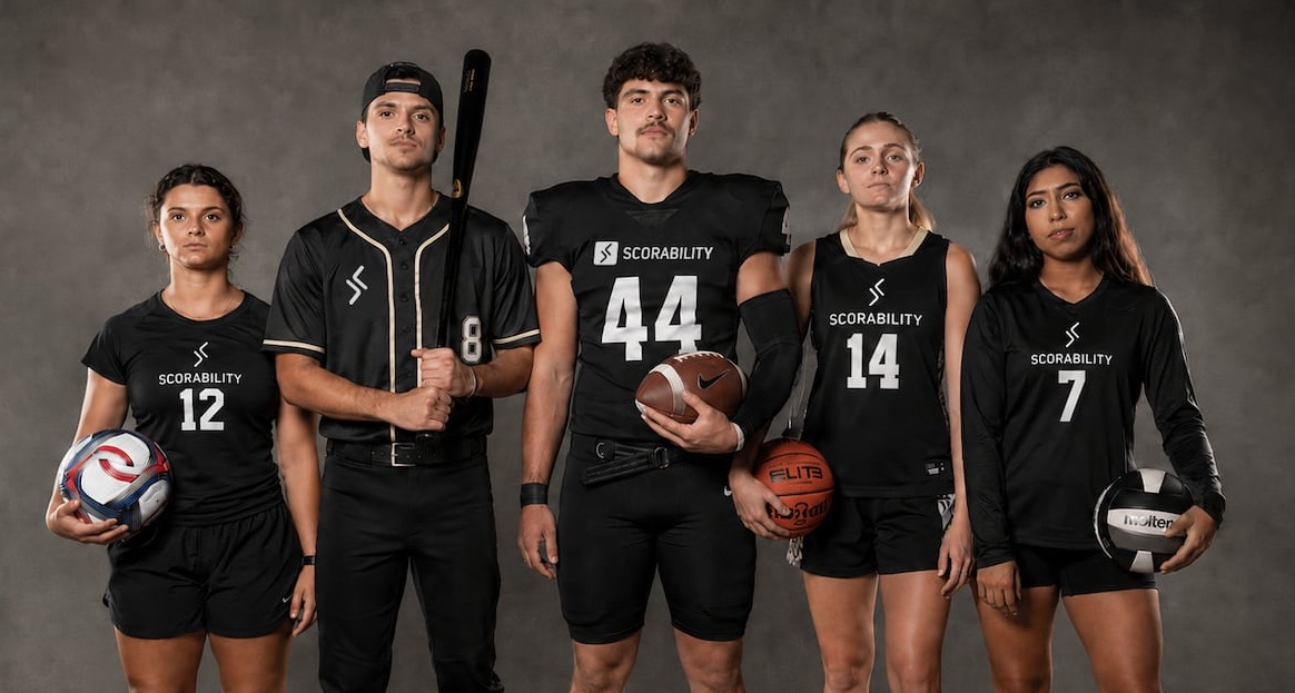 image shows five athletes standing in a line wearing and holding athletic equipment