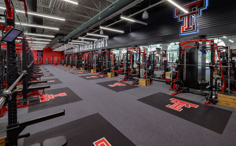 A view inside the Texas Tech University Sports Performance center with weight racks and benches.