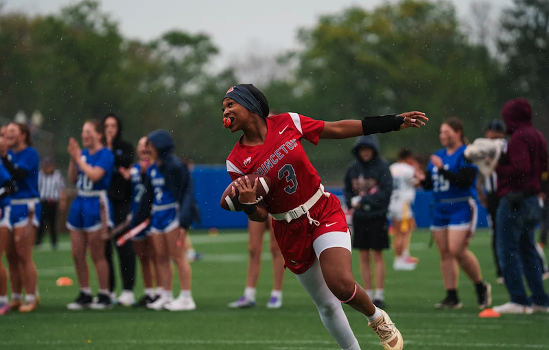 image shows girls playing in a high school flag football game