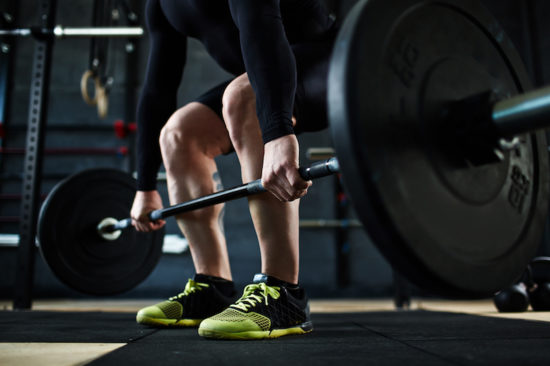 image shows the bottom half of a person deadlifting