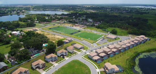 Overview of sports field with housing options next door